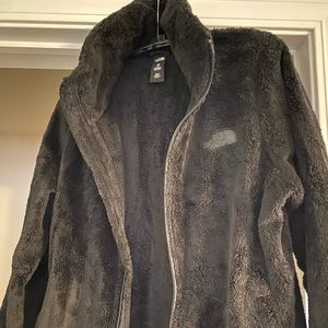 Black womens North Face zip-up fleece jacket.
